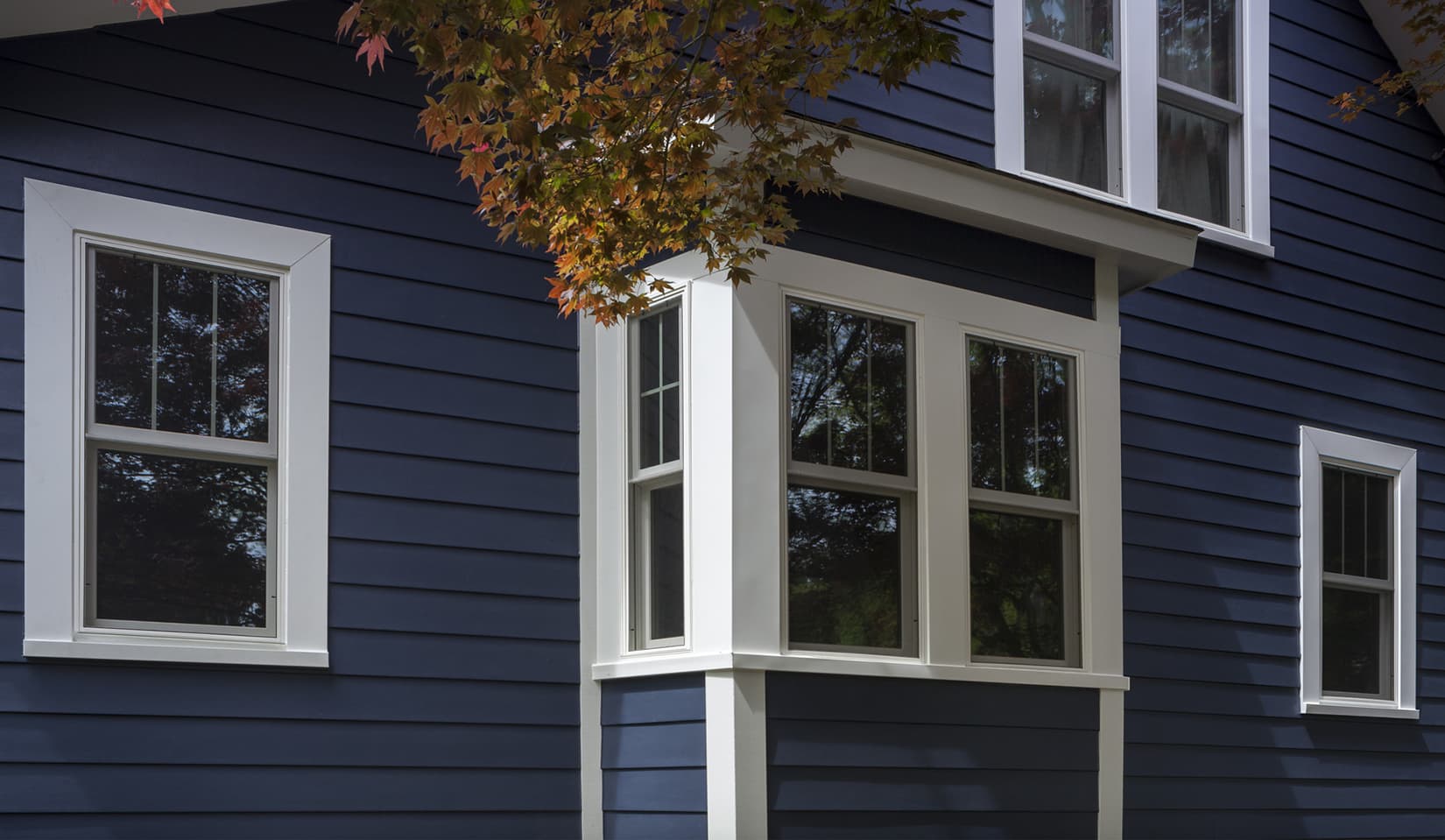 Close up view of the James Hardie siding installation in blue for a customer