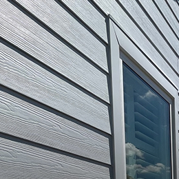 close up of wood look siding and trim around a window