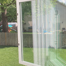 window with clear glass opening up into back yard surrounded by fencing