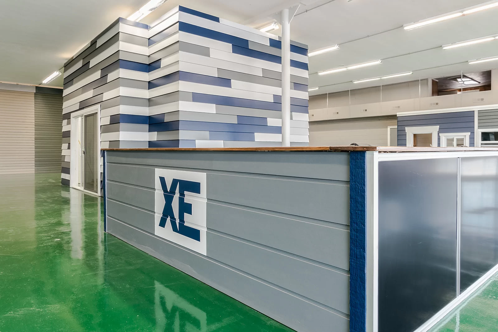 Xtreme Exteriors showroom with green flooring