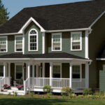 angled view of a large home with green ascend vinyl siding