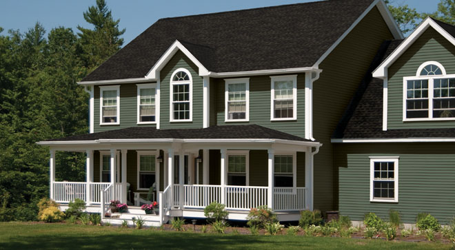 angled view of a large home with green ascend vinyl siding