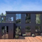 front view of a black modern home with large windows showcasing the aspyre collection exterior options