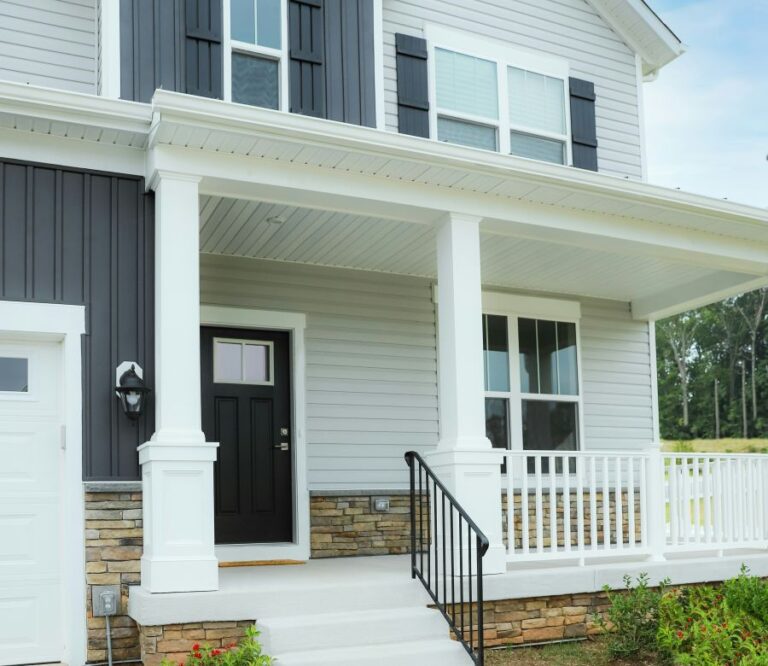 a front porch with board and batten siding, a popular trending choice in 2024