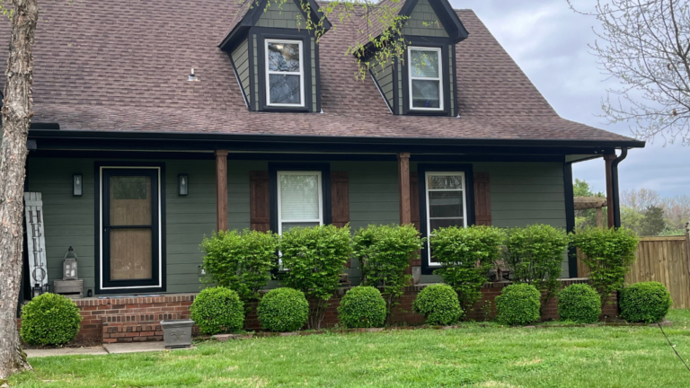 Green home with white windows Xtreme Exteriors in Nixa, MO