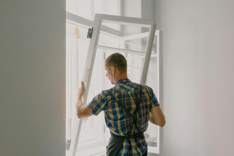 a contractor installs vinyl windows in a home