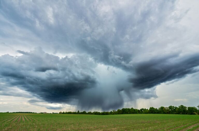 storm clouds gathering over a field in the Midwest