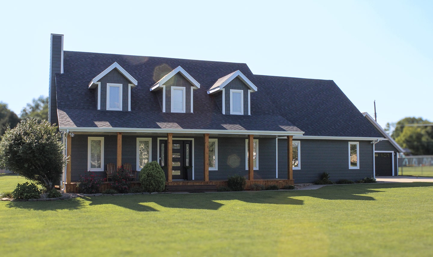 House with a black roof and black siding that had an exterior painting by exterior painters in Kansas