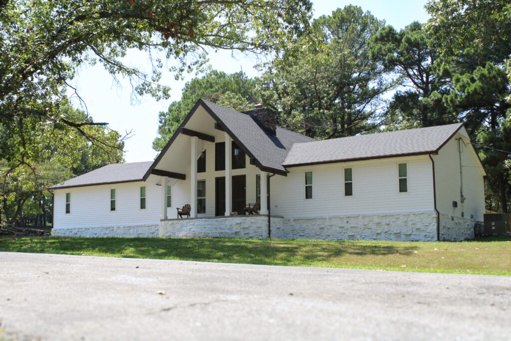 black roof with a white house Xtreme Exteriors in Nixa, MO