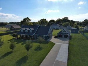 Aerial view of a suburban home with a detached garage and green lawn in Springfield.