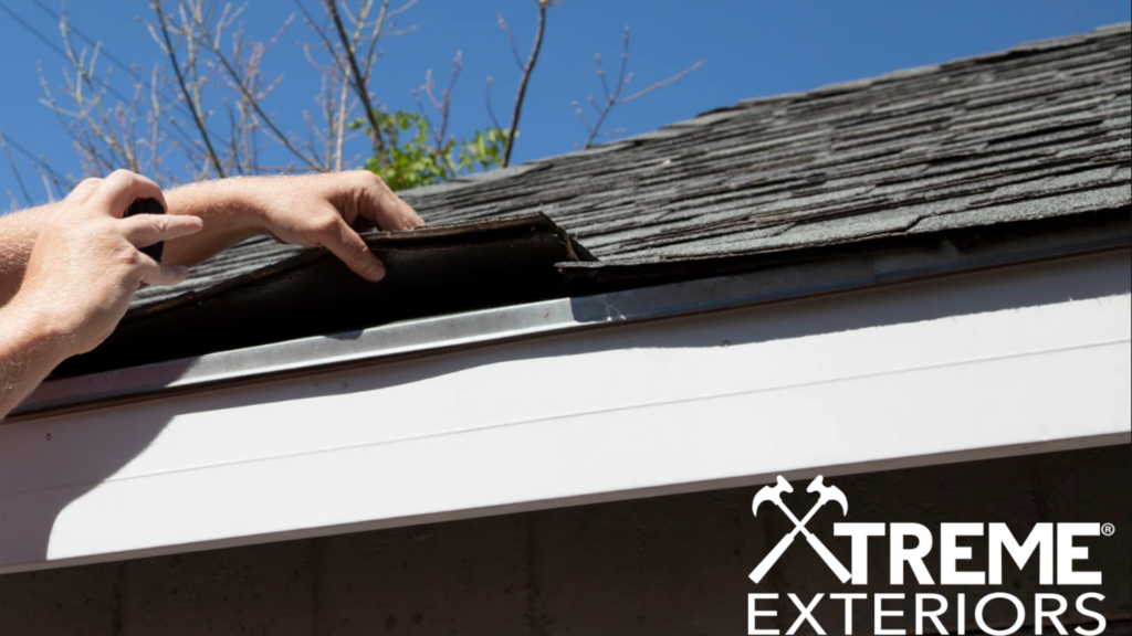 Xtreme Exteriors contractor holding a roof piece for roof replacement service