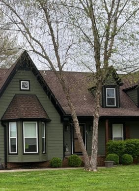 Brown shingle roof and green siding on a house by Xtreme Exterior siding contractors