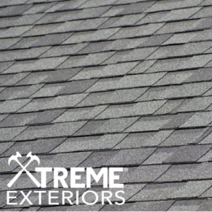 Gray asphalt shingle roof with the logo of Xtreme Exteriors for their roof replacement services