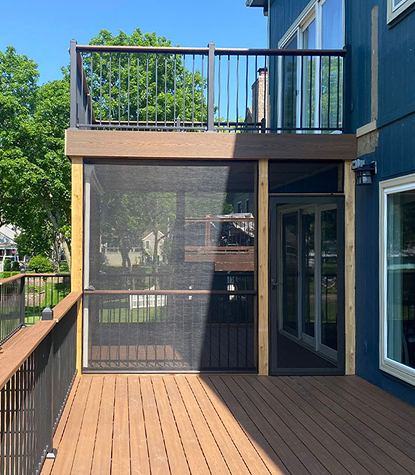 Custom screened-in porch and upper deck with composite wood flooring and black railings, new exterior renovation by Xtreme Exteriors