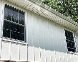 Board and batten siding and double-pane energy-efficient windows on a residential exterior by Xtreme Exteriors