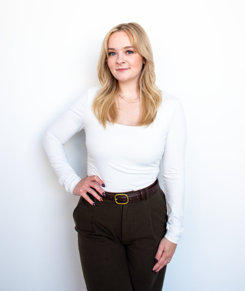 Karah Evans posing in a relaxed and professional manner for the Xtreme Exteriors employee spotlight