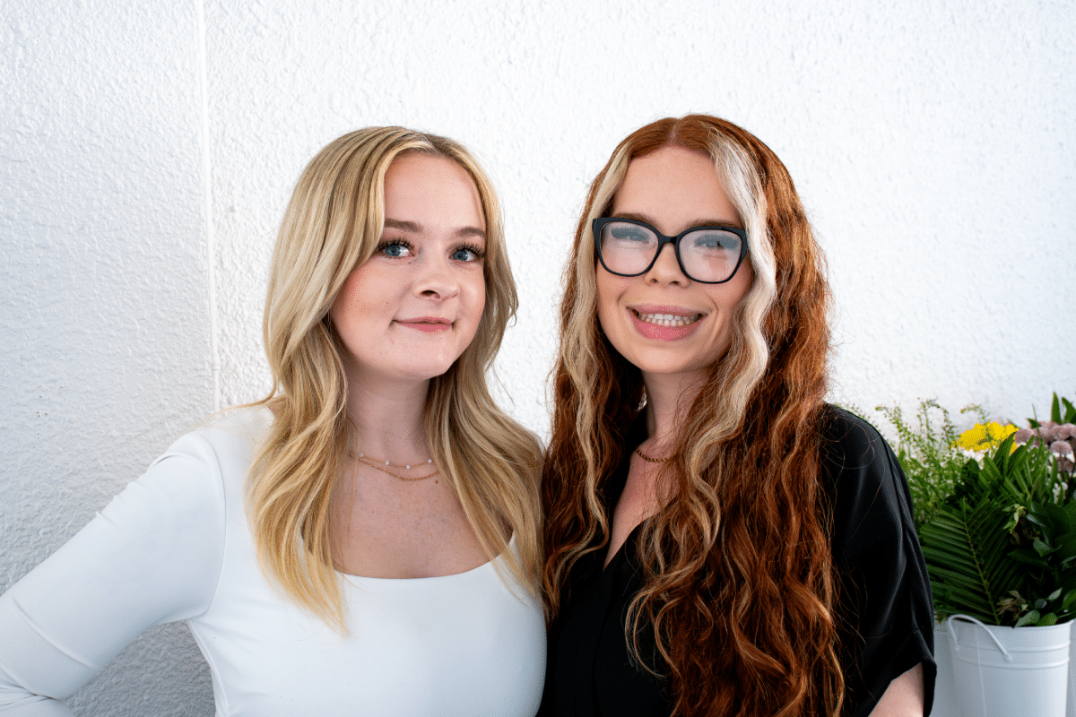 Karah Evans smiling alongside a colleague during a team moment