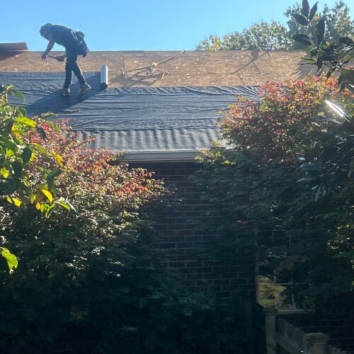 Ongoing roof replacement with Owens Corning shingles by Xtreme Exteriors crew on a residential home