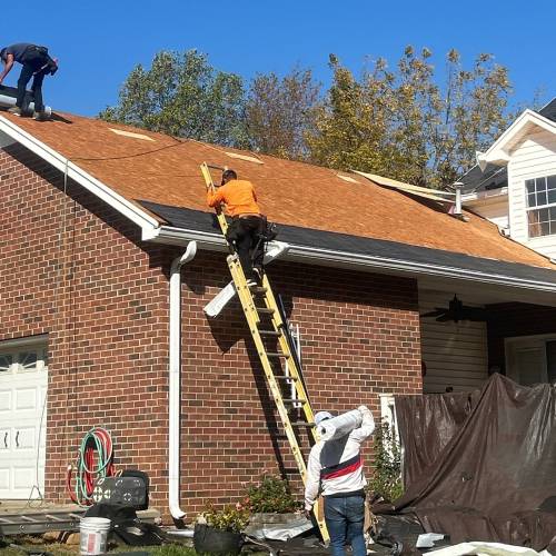Xtreme Exteriors roofing crew installing Owens Corning shingles during roof replacement project