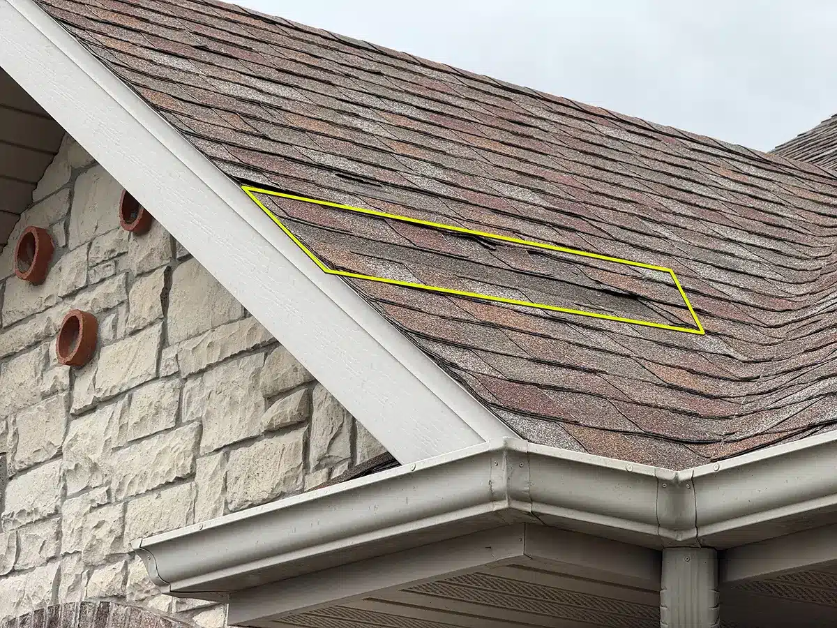 Header featured image illustrating asphalt shingles with visible storm damage and a yellow outline highlighting affected areas, supporting insurance roof damage claims services by Xtreme Exteriors