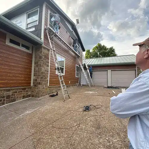 Professional crew performing emergency siding repair on a home in Sikeston by Xtreme Exteriors