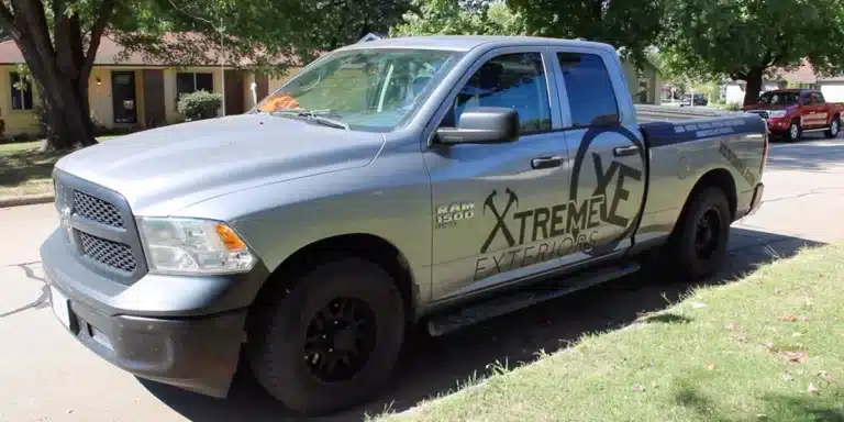 Xtreme Exteriors branded service truck parked on residential street for emergency siding repair Pittsburg