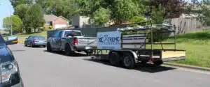 Branded Xtreme Exteriors truck and mobile siding trailer parked curbside for emergency siding repair Nixa by Xtreme Exteriors in Nixa, MO