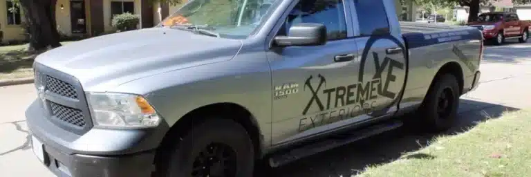 Xtreme Exteriors service truck parked on residential street, representing emergency siding repair Shawnee