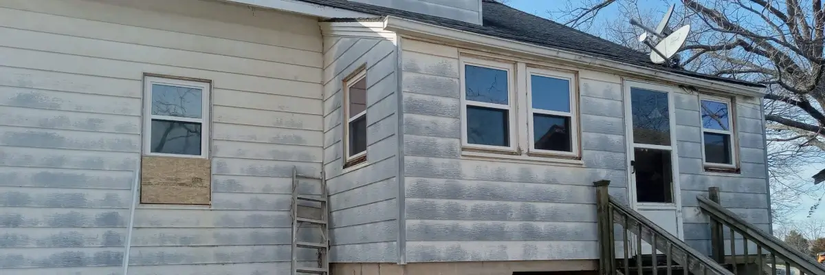 A house undergoing exterior renovation with new siding and a ladder by Xtreme Exteriors in Nixa, MO