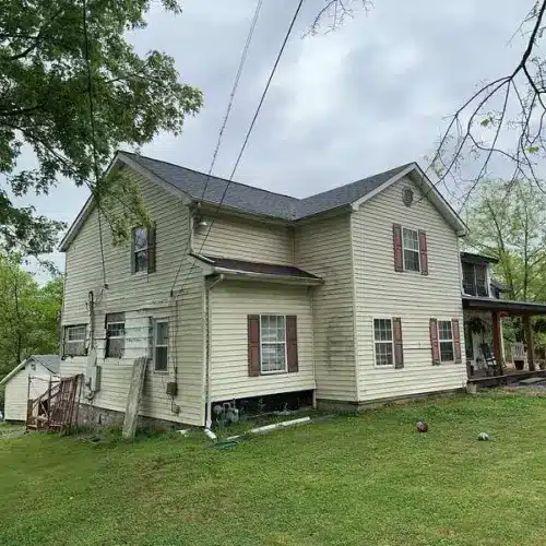 Residential home with visible siding wear and discoloration, illustrating the importance of siding maintenance Sikeston by Xtreme Exteriors in Nixa, MO