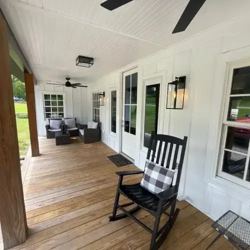 Clean white porch with pristine siding, exemplifying siding maintenance Sikeston by Xtreme Exteriors in Nixa, MO