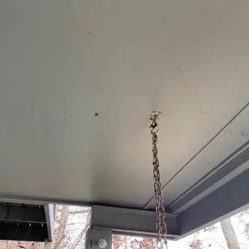 Clean covered patio ceiling with hanging chain and sturdy trim details, part of guide to siding improvements by Xtreme Exteriors in Nixa, MO