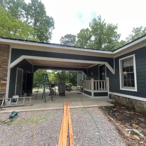 Contemporary covered patio featuring new blue lap siding, white trim, and exposed beams at a Nixa, MO home, installed by Xtreme Exteriors as part of a guide to siding