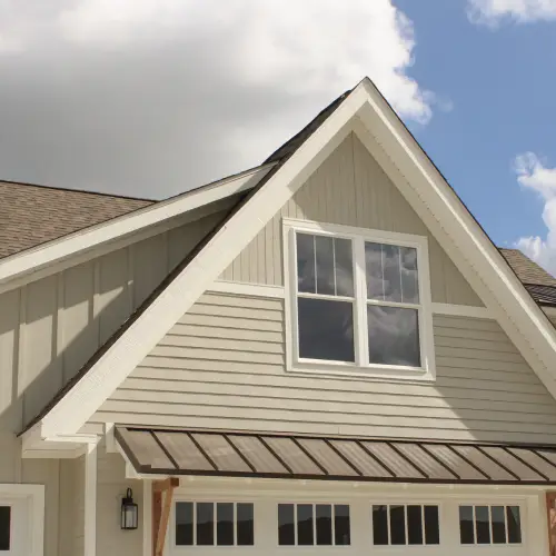 Home exterior in Nixa, MO showcasing mixed siding styles with vertical and horizontal panels