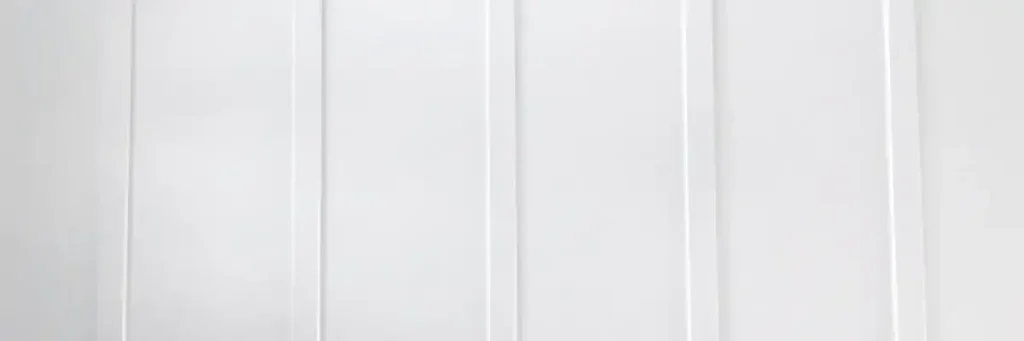 Close-up view of sleek white vertical siding panels showcasing modern siding styles in Nixa