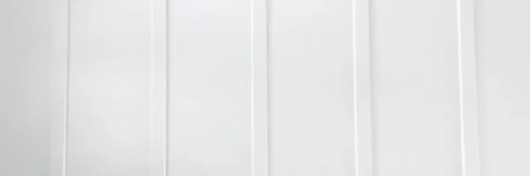 Close-up view of sleek white vertical siding panels showcasing modern siding styles in Nixa