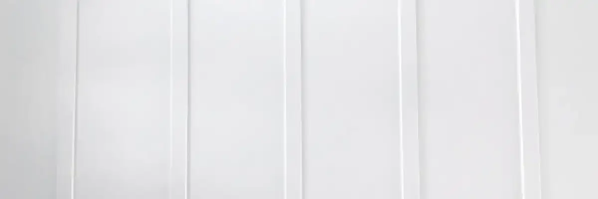 Close-up view of sleek white vertical siding panels showcasing modern siding styles in Nixa