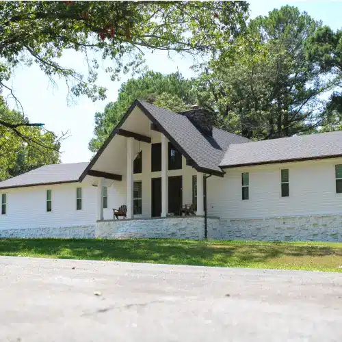 Front view of a modern home with white siding and dark roof showcasing Xtreme Exteriors siding Nixa, MO styles in Pittsburg