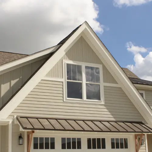 Modern home in Springdale featuring stylish and durable siding installed by Xtreme Exteriors in Nixa, MO, showcasing a blend of board and batten with horizontal lap siding.