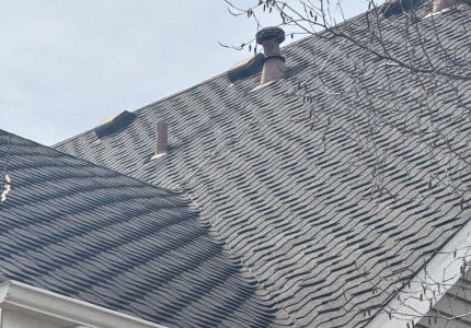 Comparison of an old low-slope roof and a newly installed steep slope roof.